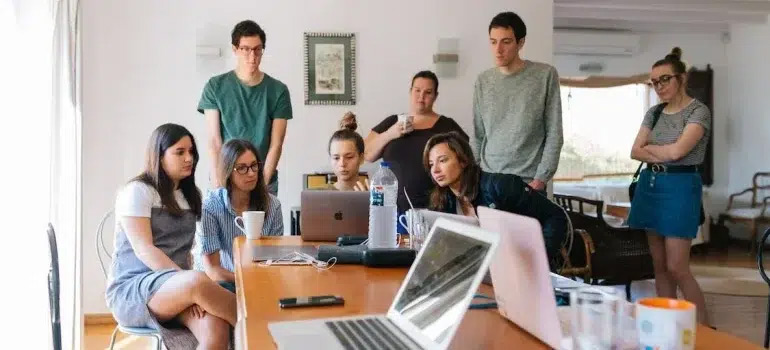 group of people looking at laptop