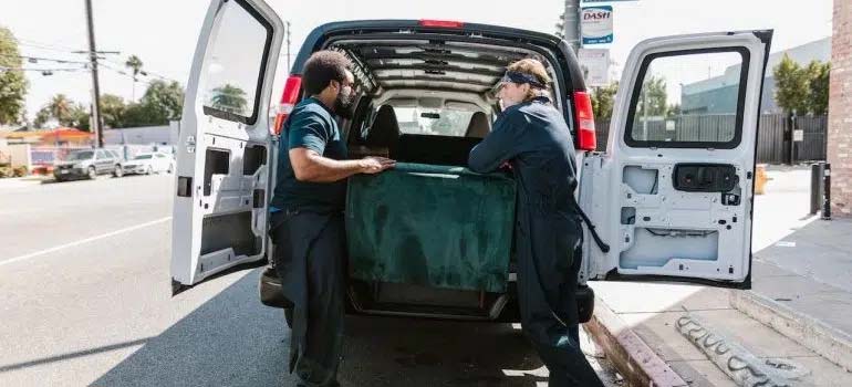 two men moving luggage from car