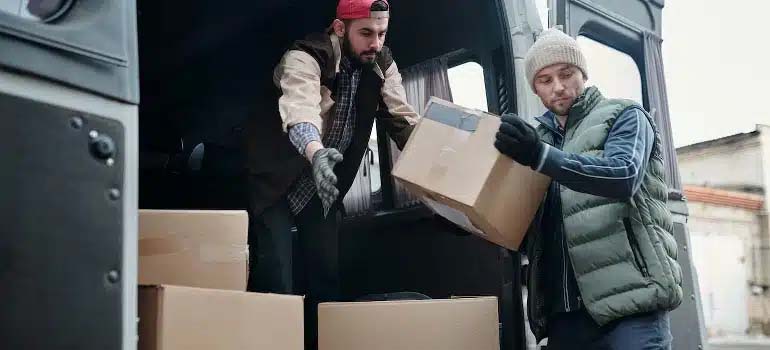 two men moving boxes