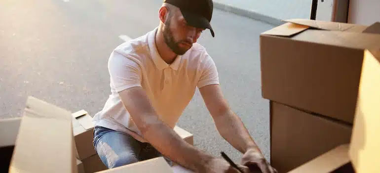 A man writing on a box