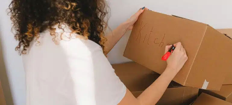 Girl writing on a box