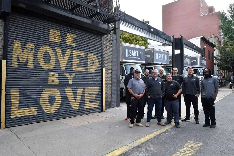 The U.Santini team stands in front of a storage unit in New York City
