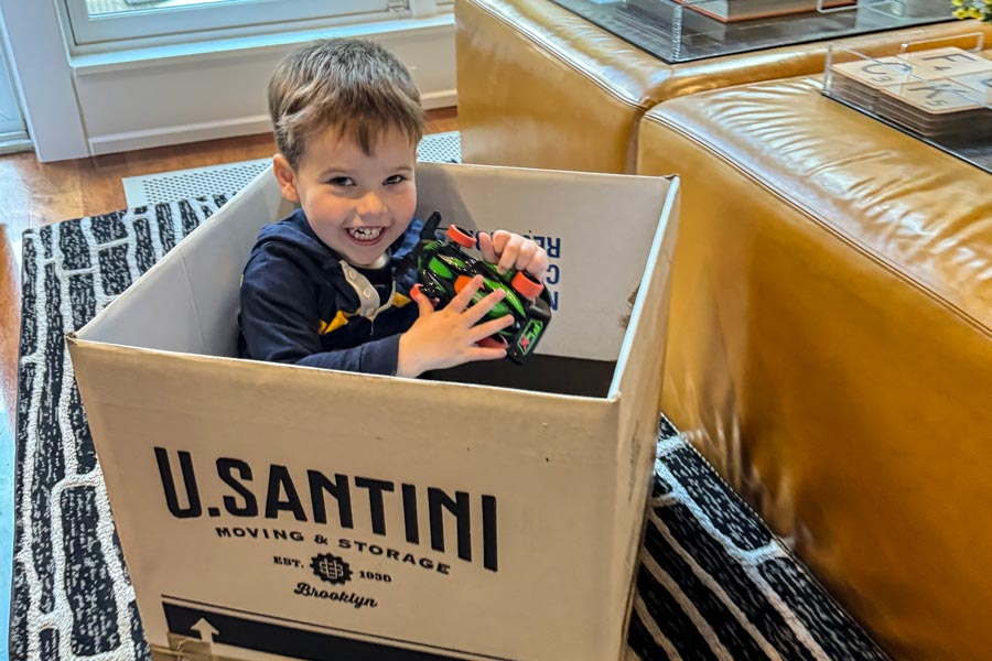 Young toddler in U.Santini box