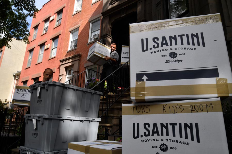 U.Santini workers carrying boxes out of the building