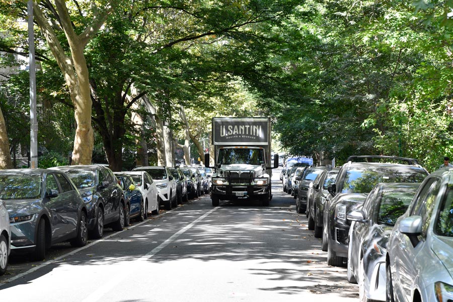 U.Santini truck going down a busy neighborhood